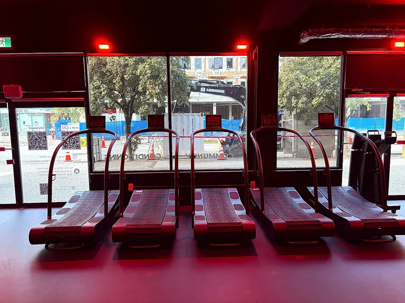 Treadmills under red lighting at the North Vancouver studio