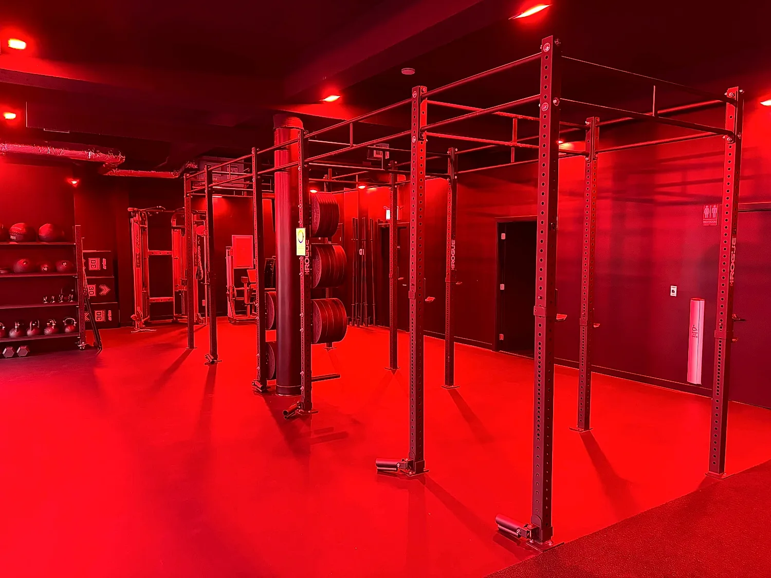 Training floor and rig under red lighting at the Coresa studio in North Vancouver